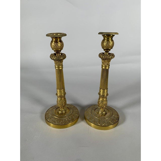 Pair of gilt bronze candlesticks, finely chased and guilloché, Empire period, decorated with baskets of fruit, finely...
