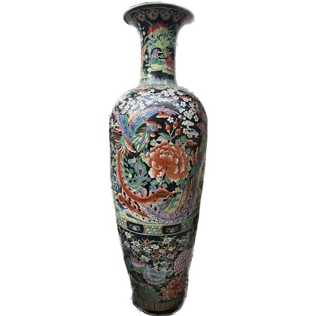 An exquisite pair of monumental hand painted blackground Chinese porcelain Urns. lead based glaze. Bottle shaped body with...