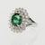 14k White gold ring set with 1 oval green tourmaline weighing 4.30 carats and 34 round diamonds weighing approximately...