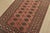 A tribal Bokhara rug hand-knotted with fine wool on a cotton foundation. This rug features rows of repeating medallions...