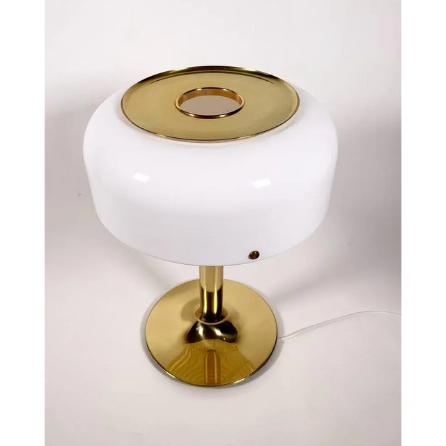 Knubbling brass table lamp with plastic shade. The Knubbling lamp is a sibling to the Bumling lamp designed by Anders...