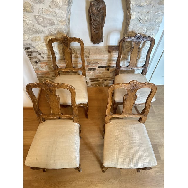 Four original Baroque chairs, circa 1760 Walnut Height: 100 cm Width: 46 cm Depth: 44 cm Seat height: 50 cm Signs of wear,...