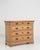 A French oak chest of drawers with a simple, structured form. The piece features multiple storage drawers set within a...