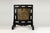 This black lacquer table screen has a multi –panel frame. Each section surrounding the stone has an elongated open...