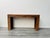 An Italian three drawers with brass handles console table with amazing lateral design carved into a solid oak wood frame ....