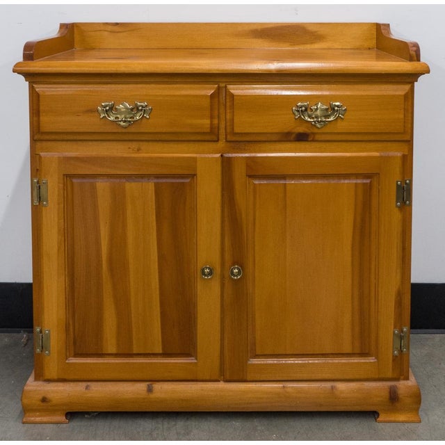 An Early American Solid Pine Two-drawer Stotage Side Cabinet in great vintage condition by Mastercraft furniture. Measures...