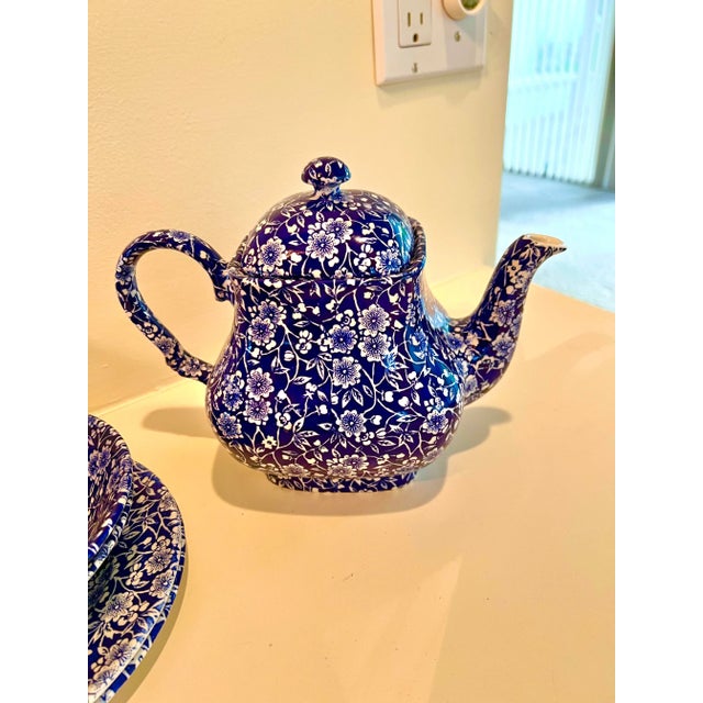 Calico blue Chintz pattern tea set. Blue with white flower chintz pattern. The Tea-Coffee pot - has Staffordshire England...