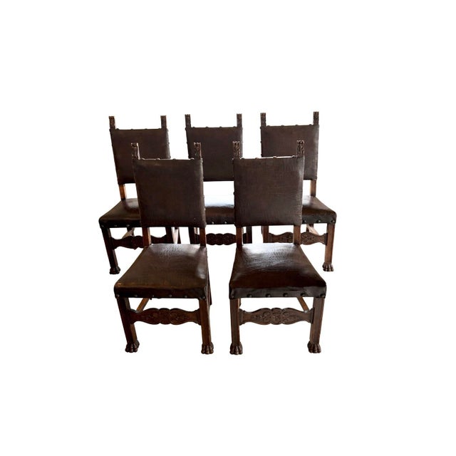 A substantial set of five late 19th-century antique carved wood dining chairs, dating to approximately circa 1880–1900....