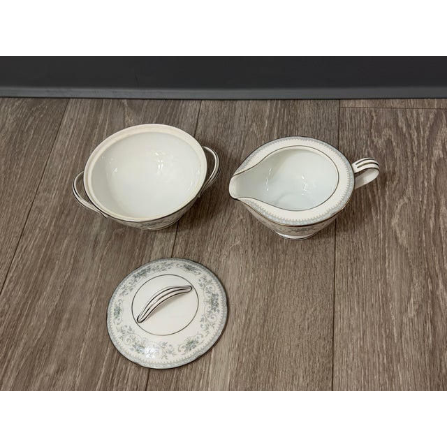 A beautifully preserved Noritake “Colburn” cream and sugar set, showcasing the refined elegance that made mid‑century...