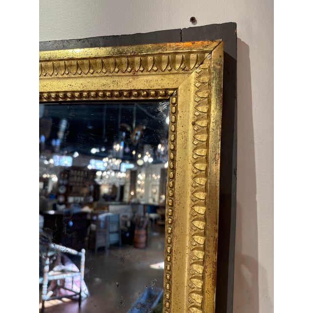 French Louis XVI mirror with original split mercury mirror and gilt frame set in darker green frame 40” x l x 70”h 35-049