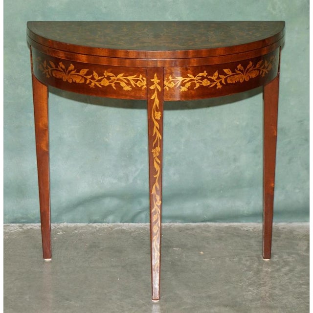 Elegant mahogany and marquetry demilune games table, dating to the 19th Century circa 1870 The table has a beautifully...