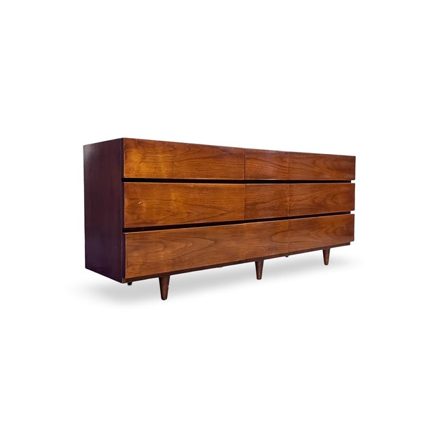 This mid-century modern lowboy dresser by American of Martinsville combines understated elegance with functional design....