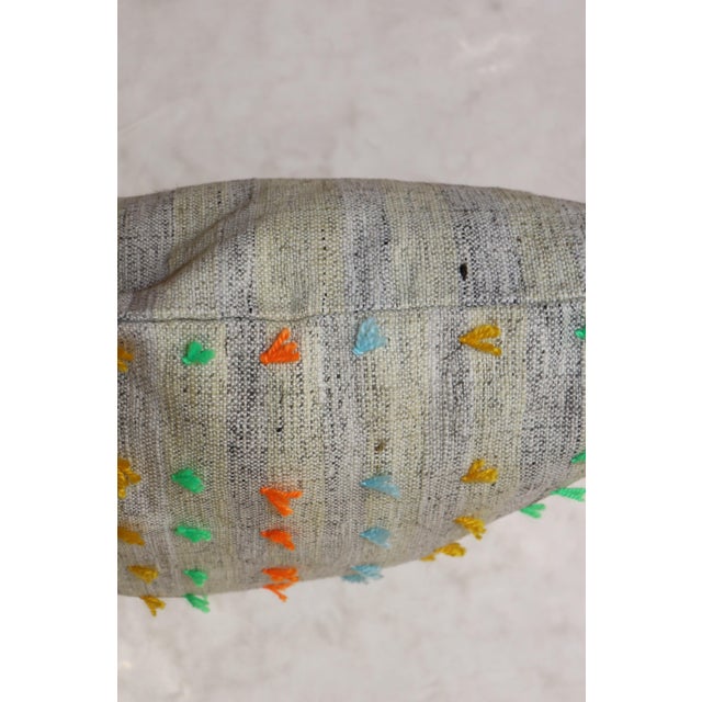Large Pillow made from a kilim with pops orange and green wool flaring out