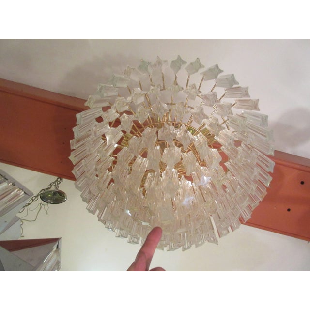 Very impressive seven-tiered chandelier with glass crystals that have polished angled ends. Crystals are placed very close...