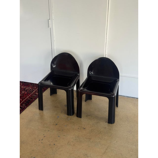 Pair of Model 4854 chairs designed by Gae Aulenti for Kartell, 1970s. Constructed from molded ABS plastic with a high...
