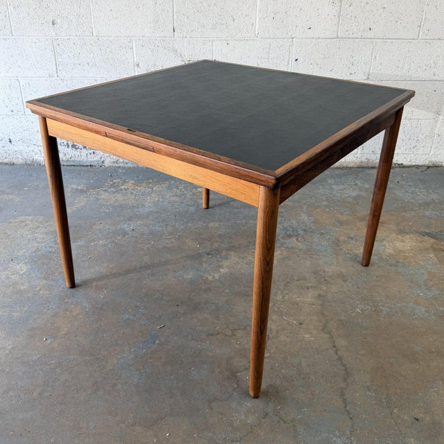 A vintage Danish rosewood game table by Poul Hundevad, dating to the 1960s. The removable square top can be reversed, with...