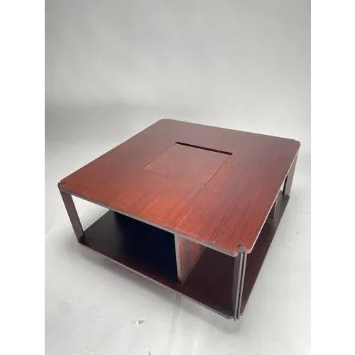 Mid-century Italian coffee table, very elegant and square in shape, with a singular object holder in the centre. The side...