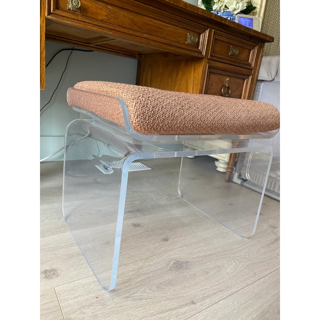 Outstanding vintage waterfall lucite bench or vanity stool that swivels. It has an upholstered cushion with a zipper....
