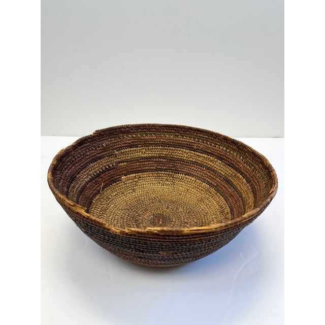 Wicker and leather antique African baskets. Leather is applied around the rim of two and the bottom of one basket. They...