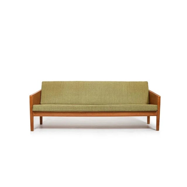 Oak sofa by illum wikkelsø for søren willadsen’s møbelfabrik, early 1950s. Dismountable frame with loose cushions. Conical...