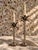 A striking pair of palm tree candlestick holders by Andrea by Sadek, featuring sculptural palm frond tops, elegantly...