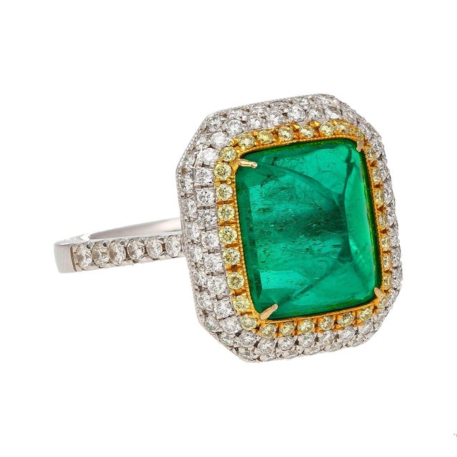 Unveil luxury and sophistication with our remarkable 4.49 carat sugarloaf cabochon cut emerald ring. Crafted with...
