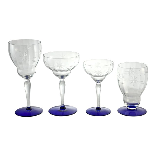 Antique 16 piece set cobalt blue-footed panel crystal stemware with a hand-cut stars and flower pattern, circa 1920. A...