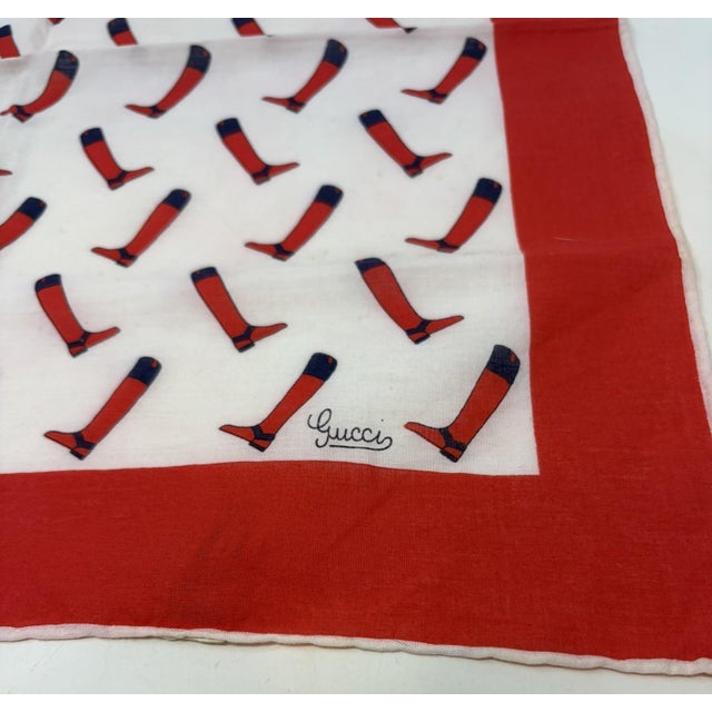 Gucci Cotton Scarf. Red border with a white center that is filled with red and navy riding boots. Gucci is in the lower...