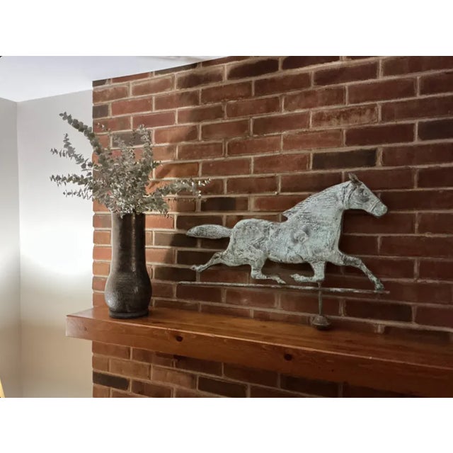 A set of two modern handmade pottery vases by Donna Karan New York, featuring an earthy taupe glaze with bronze-platinum...