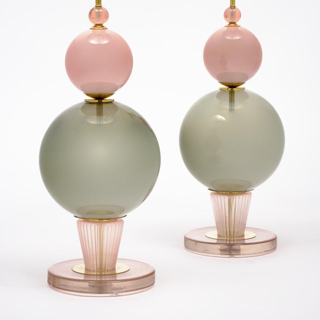Pair of hand-blown Murano glass lamps featuring unique glass components on a brass structure. In the style of iconic...