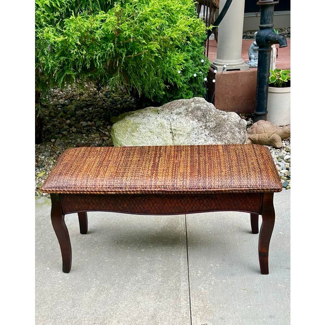 This lightweight bench has a cushioned, rattan-woven seat and smooth, curved legs. Its demur size blends well with smaller...