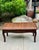 This lightweight bench has a cushioned, rattan-woven seat and smooth, curved legs. Its demur size blends well with smaller...