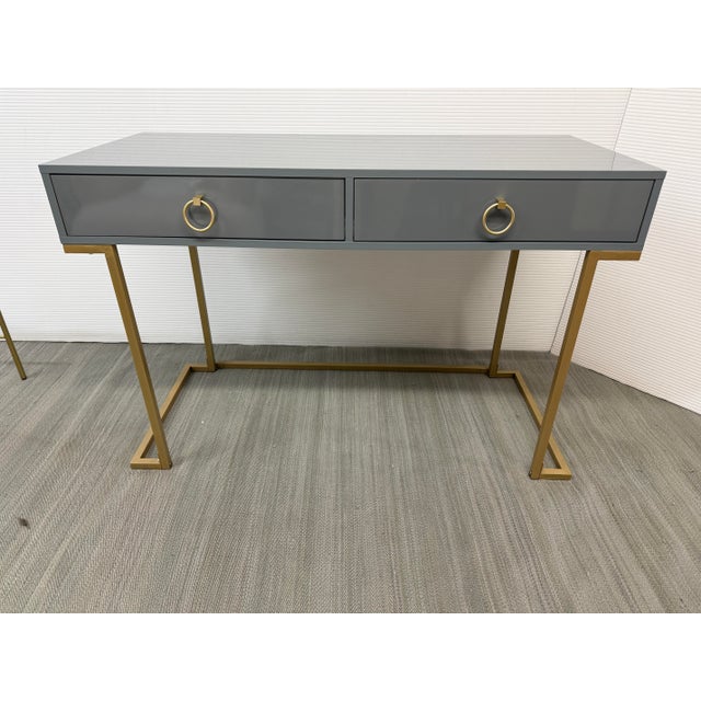 Design Plus Gallery presents a Vanity Desk by Bellezze. The desk has a modern aesthetic with a gray tone and gold accents....