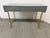 Design Plus Gallery presents a Vanity Desk by Bellezze. The desk has a modern aesthetic with a gray tone and gold accents....