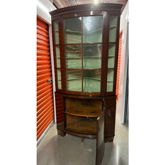 Beautiful two-piece bow front curio cabinet from Germany. Upper cabinet features decorative molding and original glass...