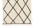 Hand-knotted wool rug showcasing a timeless Ivory foundation adorned with Midnight black diamond patterns, offering...