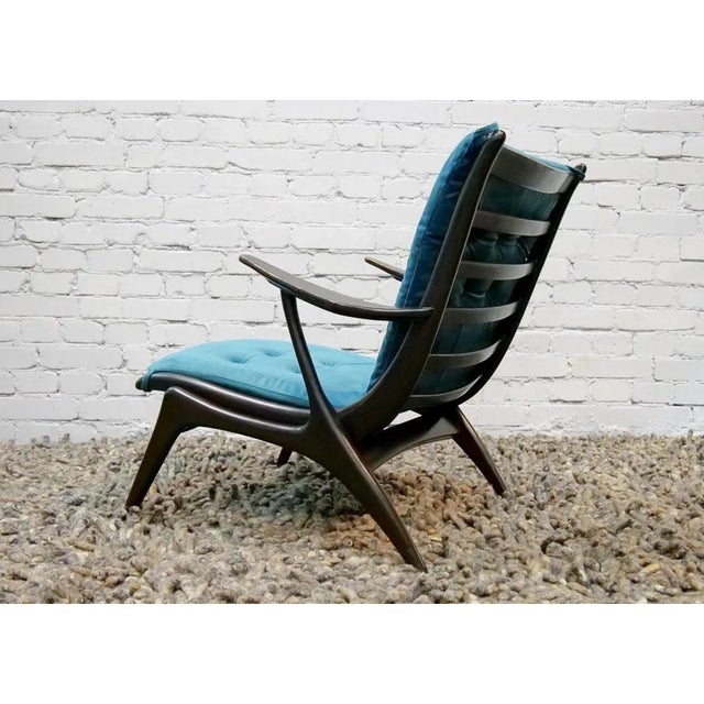 Scandinavian armchair, 50th, sculptural form of construction covered with a cylinder padding, in a dark turquoise. There...