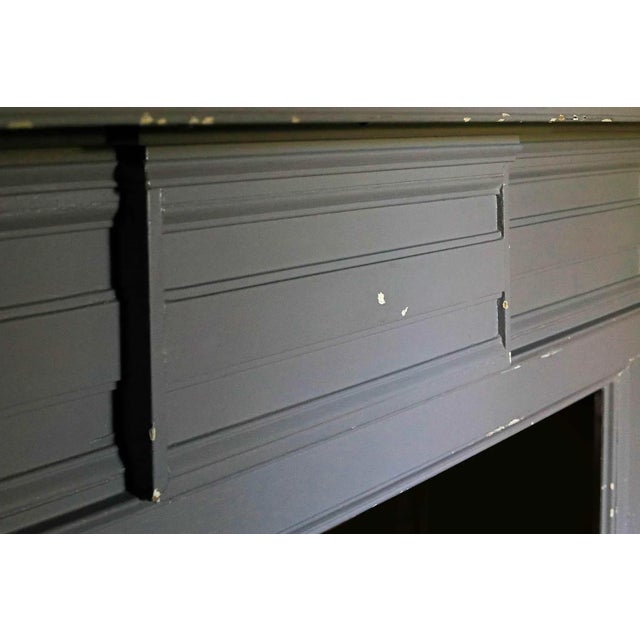Antique Federal style mantel having paneled pilaster jambs and unique variegated fluting on lintel and central tablet....