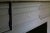 Antique Federal style mantel having paneled pilaster jambs and unique variegated fluting on lintel and central tablet....