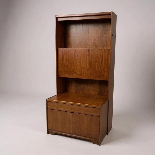 The Mid Century Highboard by William Lawrence is a stylish teak display cabinet and vintage sideboard designed to combine...