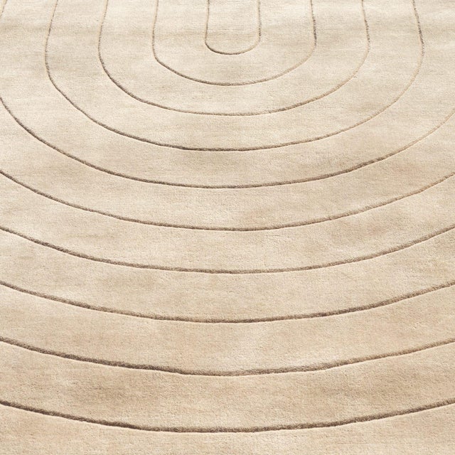 The Dune rug features a refined geometric pattern with subtle raised lines, adding texture and depth to its neutral tone....