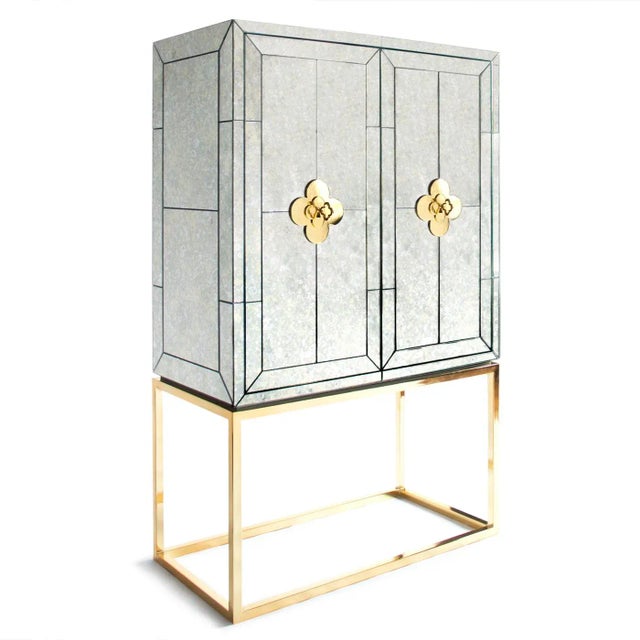 Minimalist forms meet Maximalist glamour. Antiqued mirror with a polished brass base. The robin's egg blue interior is...