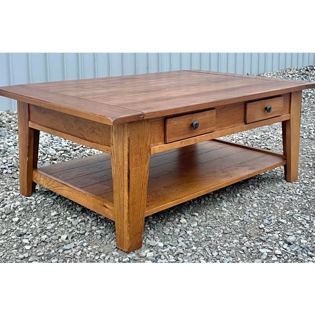 Rustic farmhouse style abounds in this solid oak coffee table by Broyhill from their very popular Attic Heirlooms...