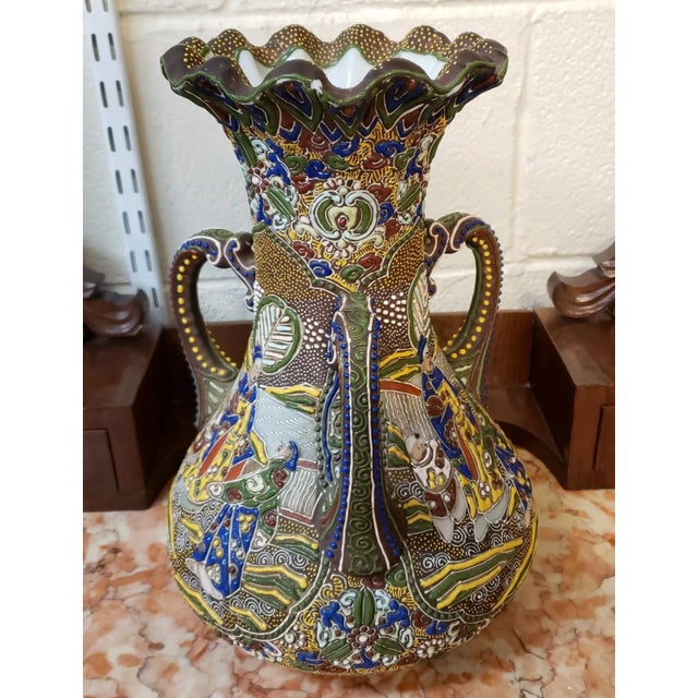 This is an Early 20th Century Japanese Moriage Porcelain Triple Handled Vase. It measures 12" tall and 8" in diameter. The...