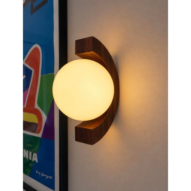 Two wall sconces, each with a mahogany wood base and two frosted opaline glass shades. 1970s. in excellent condition – no...