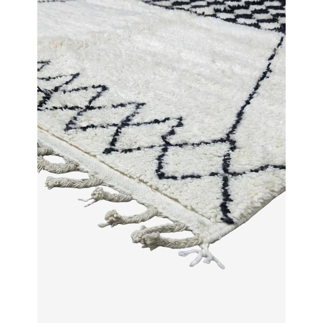 Black and Ivory Moroccan Rug – Handmade Geometric Berber Wool Rug This striking handmade Moroccan rug features a soft...
