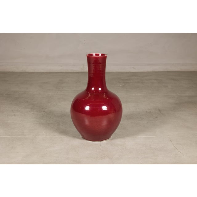 This vintage Chinese porcelain vase showcases the rich, saturated oxblood glaze that has long been admired by collectors...