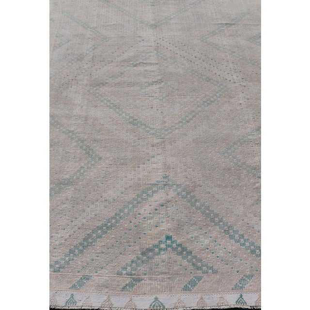 Embroidered vintage Kilim rug from Turkey in shades of tan, light green, light gray, and cream with geometric pattern,...
