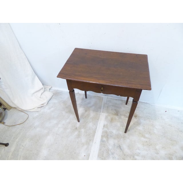This 18th Century French side table with fluted apron has pegged construction and a dove-tailed drawer.