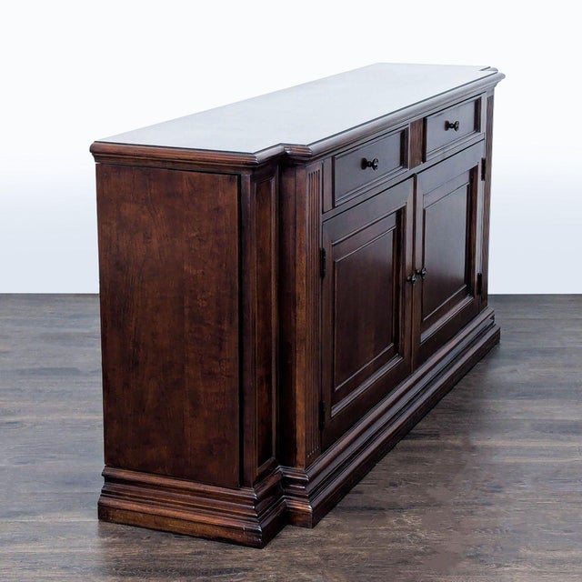 This Ethan Allen sideboard and credenza features a classic wood design with two spacious drawers and double-door cabinets....